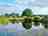 Old Buckenham Country Park: View from the covered outdoor area by the pond and the park 