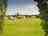 Sunnydale Farm Camping and Caravan Site: Through the park's trees on a sunny day (photo added by manager on 06/20/2025)