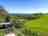 Womerton Farm Campground: View of the pitching field and check-in caravan in the sunshine (photo added by manager on 29/06/2023)