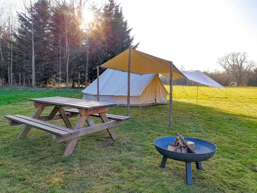 Wye Tipi Camping: Family bell tent setup: 5 metre bell tent, canvas dining shelter, picnic bench and firepit