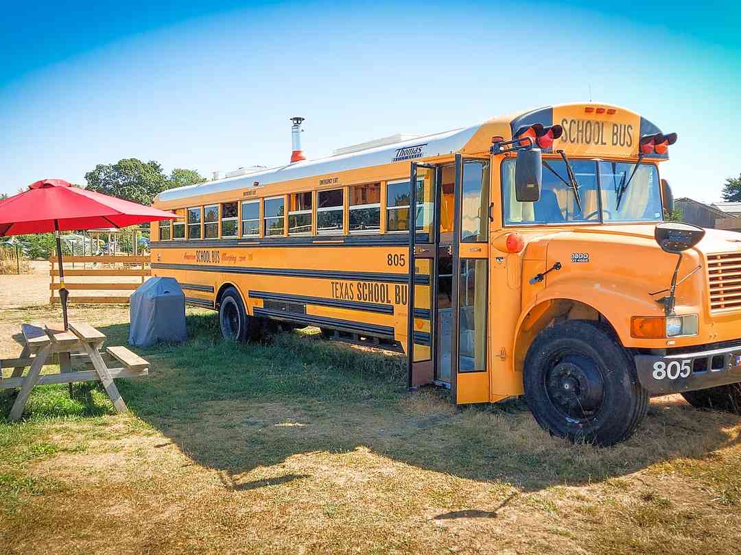 American School Bus Glamping at Isle of Wight: School bus and alfresco seating (photo added by manager on 02/02/2023)