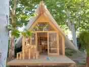 Tipi on a wooden deck among the trees