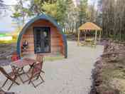 Outside area with covered picnic bench and lighting