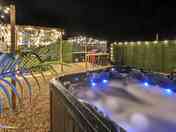 Hot tub lit up after dark