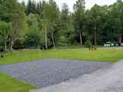 Hardstanding pitch with grass to the side