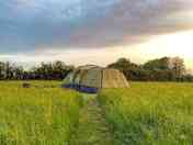 A grass tent pitch looking south west