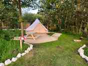Beautiful 5m bell tent with 4 camp beds. Private garden area with picnic table and a small fire pit.