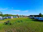 A view of one of the non-electric grass tent pitches near one of the fishing ponds. (added by manager 21 May 2024)