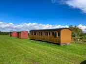 External view of carriage camping pod alongside box wagon camping pods (added by manager 17 Apr 2024)
