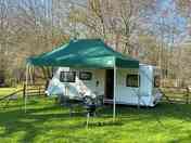 Covered seating area with garden furniture and barbeque are also provided.