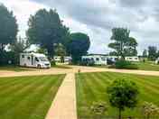 View to the tree-shaded pitches (added by manager 15 Jan 2024)