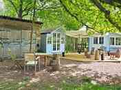 Decking area, covered kitchen, seating, gazebo, fire pit and external view of the cabins