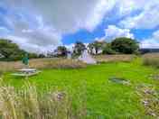 The bell tent pitch with a firepit and picnic bench