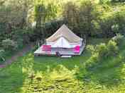 Red bell tent on decking