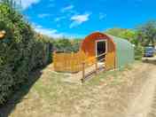 Camping pod with a fence