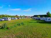 A view of one of the non-electric grass tent pitches near one of the fishing ponds.