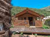 Tent backed by forested hills