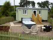 Exterior of the shepherd's hut showing hot tub