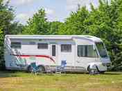 Grass pitches surrounded by trees for shade