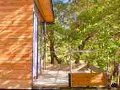 The cabin's balcony overlooking oak trees