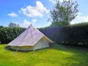 Bell tent with grass area and parking