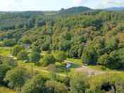 Aerial view of the site's forest setting