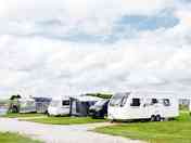Large fully serviced hardstanding pitch with grass area