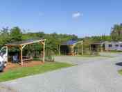 Pine Views fully-serviced grass and gravel touring pitches with bench
