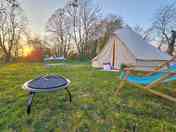 Bell tent with campfire and outdoor seating