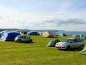 Large tent field with sea views. No set pitches so you choose where you go.