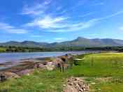 Waterside tent pitches with mountain views
