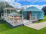 Outside the yurt, private hot tub , decking and dining area.