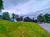 Hardstanding campervan pitches on the right and tent pitches up the bank