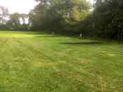 Hardstanding and grass pitch with electric hook ups.