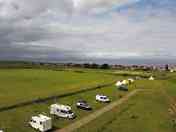 dramatic aerial view of the campsite and the sea