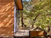 The cabin's balcony overlooking oak trees