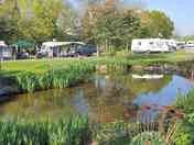 Electric hardstanding pitch by pond