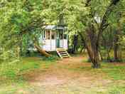 The gypsy caravan, in the old orchard under the damson and pear trees