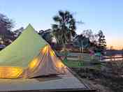 Golden hour at the lake—your cozy glamping tent, just steps from the water.