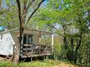 Cabin partly shaded by trees