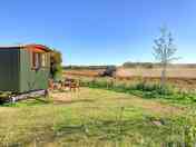 The Sussex Hut with the combine harvester doing its thing in the field (added by manager 29 Sep 2022)