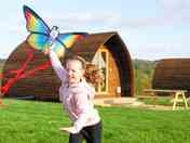 Guest flying a kite in front of the wigwam