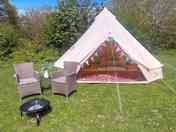 Superior bell tent with outdoor chairs and firepit