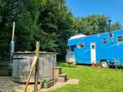 The wood burning hot tub sits next to Big Blue
