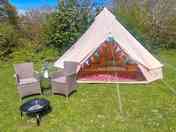 Superior bell tent with outdoor chairs and firepit