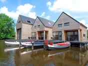 Sinnehúskes on the water, with your own boat in front of the door!