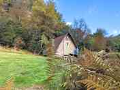 Nith Wigwam set on a tree lined bank.