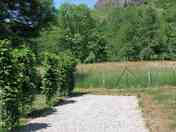 Levelled motorhome pitch, part gravel and part gras with views of the volcano