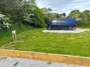 Gravel pitch with grass to side and hook up