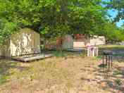 Glamping tents shaded by trees